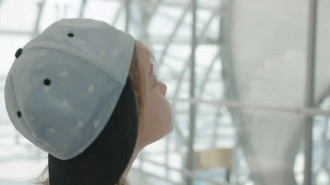 Young backpacker checking flight information on digital schedule display Stock Footage 104604907