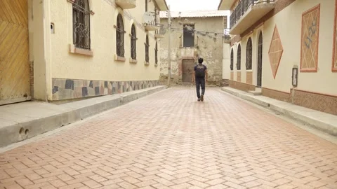Young backpacker explores the streets of an ancient city, carrying a backpack Stock Footage 276227180