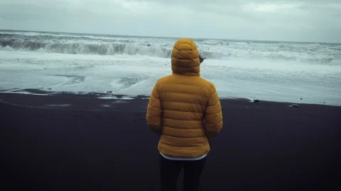 Young backpacker walking trough the famous beach of VIK in Southern Iceland Stock Footage 116044688