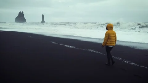 Young backpacker walking trough the famous beach of VIK in Southern Iceland Stock Footage 116049852
