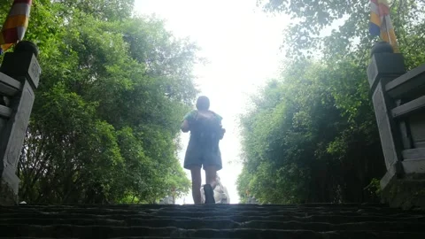 A young backpacker woman with camera exploring a temple in Asia Video stock 248514057