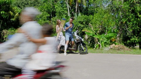 Young backpacking couple driving to hire shop after having accident on the road Stock Footage 201095975
