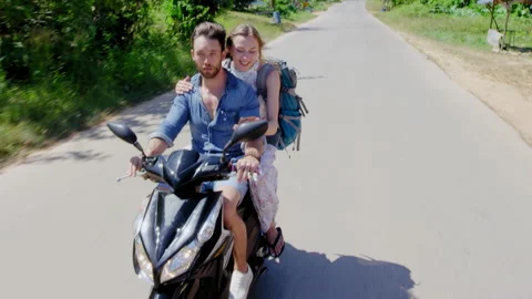 Young backpacking couple having a road trip together on hired Scooter in Thailan Stock Footage 201094732