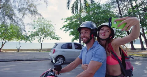 Young backpacking couple having a road trip together on hired Scooter in Ao Nang Stock Footage 201095415