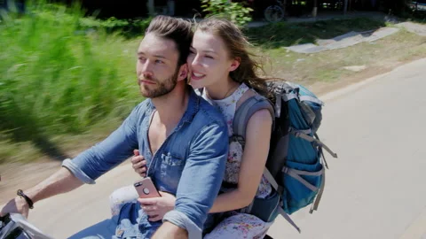 Young backpacking couple having a road trip together on hired Scooter in Thailan Stock Footage 201097050