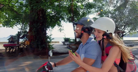 Young backpacking couple having a road trip together on hired Scooter in Ao Nang Stock Footage 201097119