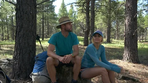A young backpacking couple take a rest and give a high five Stock Footage 94683029