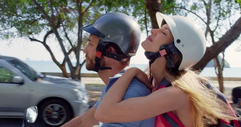 Young backpacking holiday couple having a road trip together on hired Scooter in Stock Footage 201096571
