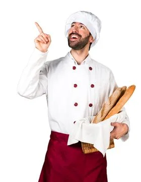 Young baker holding some bread and thinking Stock Photos