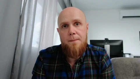 A young bald guy with a red beard nods his head in agreement: yes, yes, yes. Stock Footage 139192556