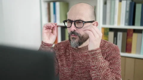 Young bald man student using computer stressed at university classroom 스톡 동영상 233397023