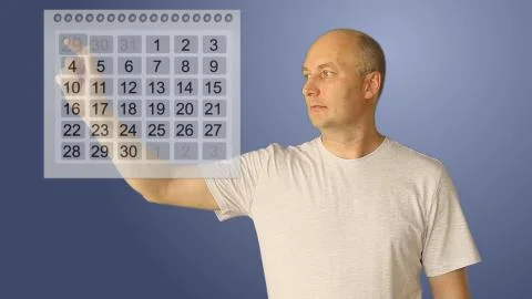Young bald man work with virtual calendar. Male choice two date for start and Stock Photos