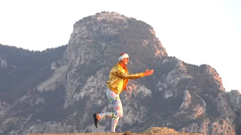 Young bald slender freak man caucasian in tight leggings, gold jacket Stock Footage 138932401