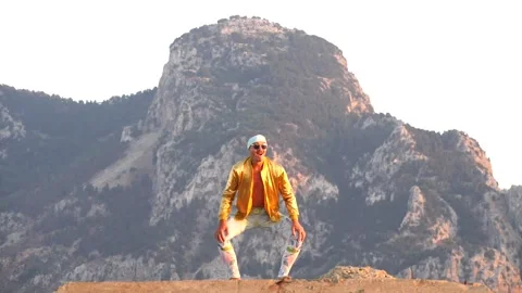 Young bald slender freak man caucasian in tight leggings, gold jacket Stock Footage 138932504