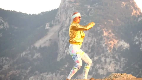 Young bald slender freak man caucasian in tight leggings, gold jacket Stock Footage 138932864