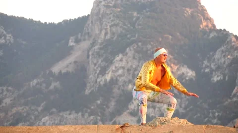 Young bald slender freak man in tight leggings, gold jacket, bandage Stock Footage 138933072