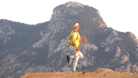 Young bald slender freak man caucasian in tight leggings, gold jacket Stock Footage 138939013