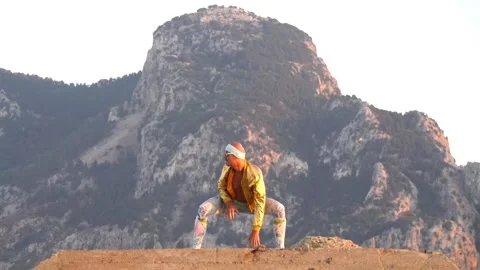 Young bald slender freak man caucasian in tight leggings, gold jacket, bandag Stock Footage 138939448