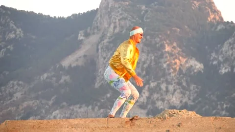 Young bald slender freak man in tight leggings, gold jacket, bandage Stock Footage 138940239