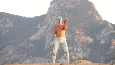 Young bald slender freak man in tight leggings, topless, bandage on his head Stock Footage 138940477