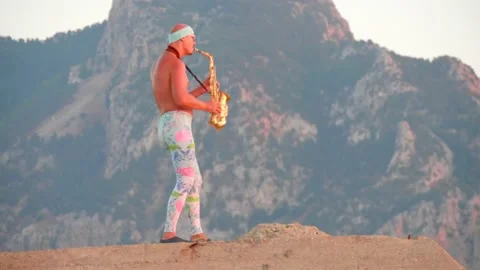 Young bald slender freak man caucasian in tight leggings, topless, bandage Stock Footage 148783260