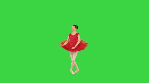 Young ballerina in red ballet tutu and pointe shoes dancing on a Green Screen Stock Footage 150387520
