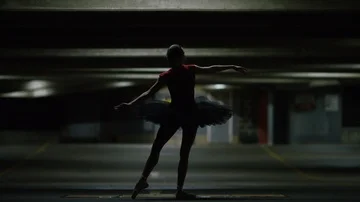Young ballet dancer doing graceful poses under a car park light, in slow motion Stock Footage 85615130