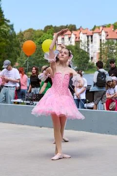 Young ballet dancer performing outdoors in pink costume Stock Photos
