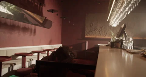 Young barman taking wine bottle from build in refrigerator Video stock 239165977