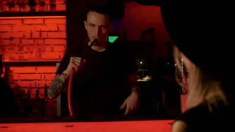 Young barman is trying hookah Stock Footage 85603569