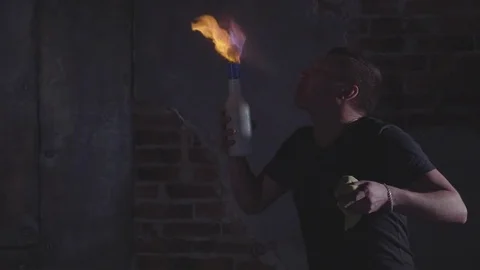Young bartender blowing fire from his mouth at barmen show, slow motion Stock Footage 81517949