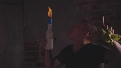 Young bartender blowing fire from his mouth at barmen show, slow motion Stock Footage 81518105