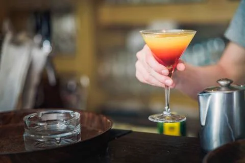 Young bartender or a waiter making a cocktail Stock Photos