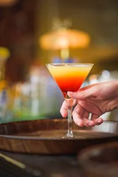 Young bartender or a waiter making a cocktail Stock Photos