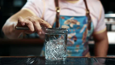 Young bartender is preparing delicious cocktail while standing at bar counter. Stock Footage 90616300