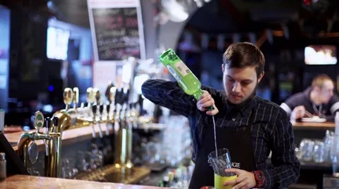 Young bartenderpreparing coctail with shaker Stock Footage 56465425