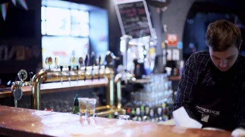 Young bartenderpreparing coctail with shaker Stock Footage 56465513