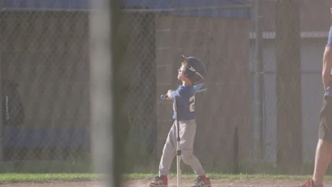 Young Baseball Player Swings Hitting Ball At Game Stock-Footage 208730354