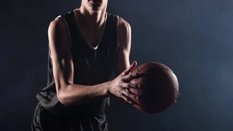 A young basketball player is practicing a serve with the ball. The guy trains Stock Footage 155016452