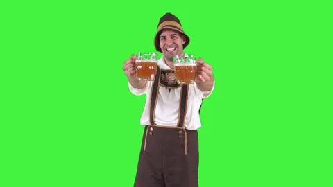 Young bavarian man holding two beer glasses towards camera to celebrate okt.. Stock Footage 281192212
