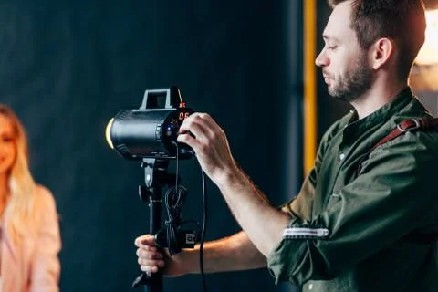 Young beaded man setting the flash Stock Photos