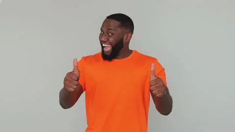 Young bearded african american guy 20s in orange basic casual t-shirt look Stock Footage 148317403