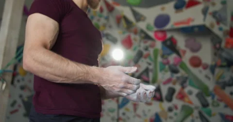 Young bearded athlete clapping hands with chalk powder preparing for training Stock Footage 131334296