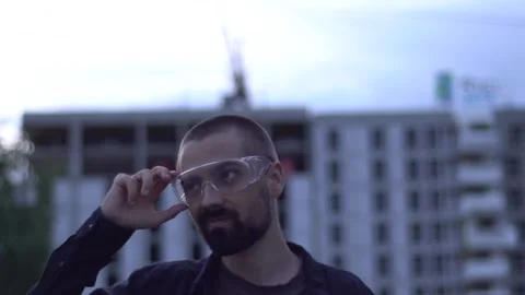 Young bearded caucasian Architect on the background of the building. Stock Footage 138810995