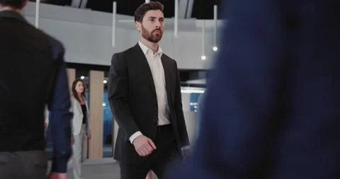 Young bearded confident businessman walking into office through business center Stock Footage 147677751