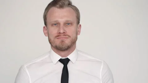 Young bearded guy applies protective mask to his face and poses for camera in Stock Footage 130810076