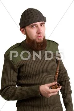 Young bearded guy smoking a pipe Stock Photos