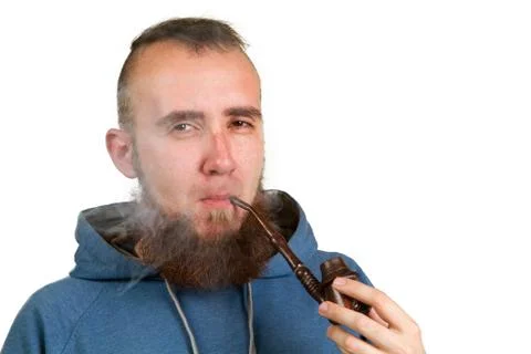 Young bearded guy smoking a pipe Stock Photos