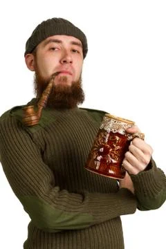Young bearded guy smoking a pipe Stock Photos
