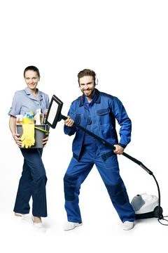 Young bearded handsome guy and a girl in a uniform of cleaners are isolated o Stock Photos